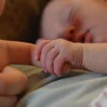 baby-holding-parents-finger-suffering-postnatal-depression