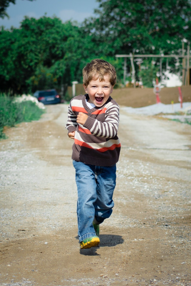 Happy boy running towards parent